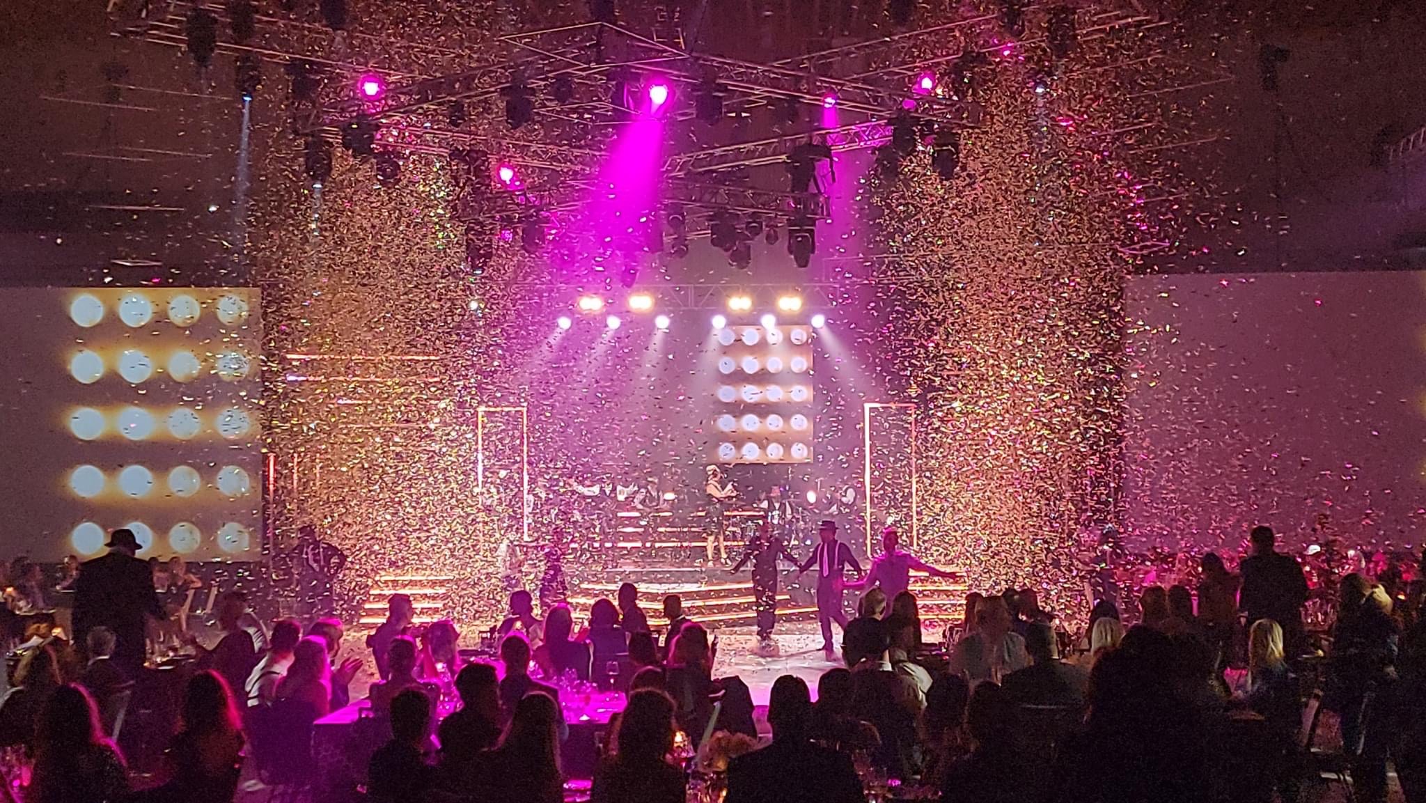 Concert with pink stage lights and confetti